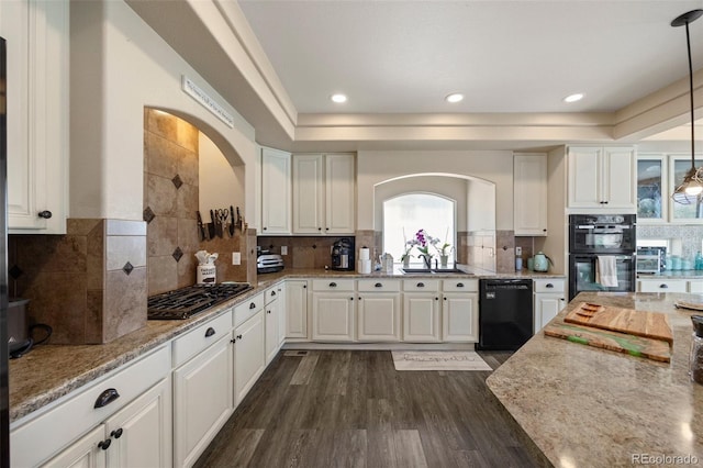 3871 Starry Night Loop, Castle Rock, CO 80109 - kitchen featuring black appliances, arched walkways, healthy amount of natural light, dark wood-style flooring, and recessed lighting