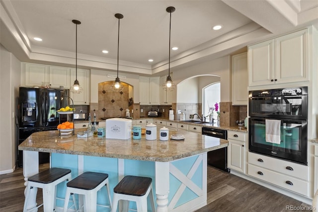 3871 Starry Night Loop, Castle Rock, CO 80109 - kitchen featuring a tray ceiling, black appliances, arched walkways, dark wood-style flooring, and recessed lighting