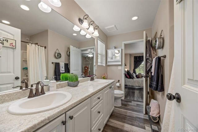 3871 Starry Night Loop, Castle Rock, CO 80109 - ensuite bathroom with wood finished floors, double vanity, recessed lighting, and a shower with curtain