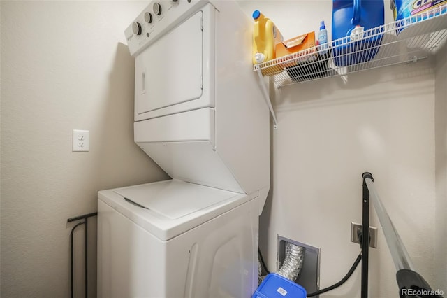 washroom featuring stacked washing maching and dryer