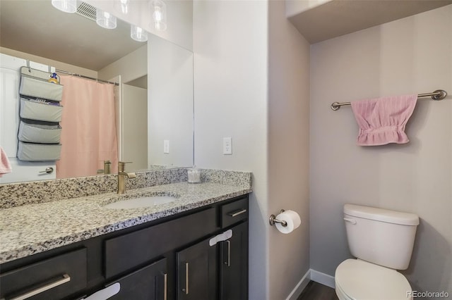 bathroom with vanity and toilet