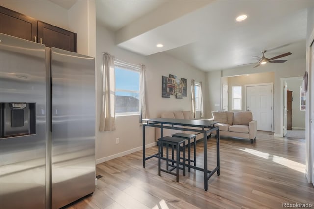 kitchen featuring stainless steel refrigerator with ice dispenser, light wood-type flooring, and a wealth of natural light