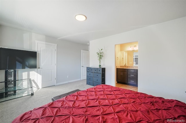 carpeted bedroom with ensuite bath