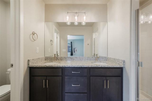 bathroom with vanity, an enclosed shower, and toilet