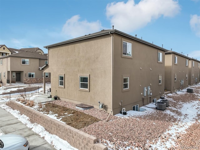 view of snowy exterior with central AC