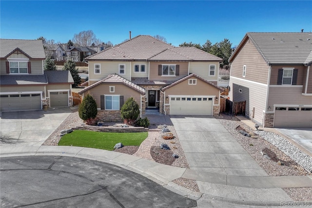 view of front of house featuring fence, concrete driveway, stone siding, a tiled roof, and a residential view