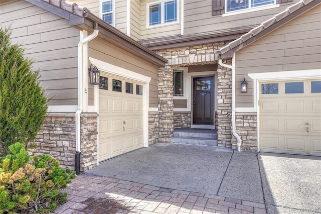 doorway to property featuring stone siding and driveway