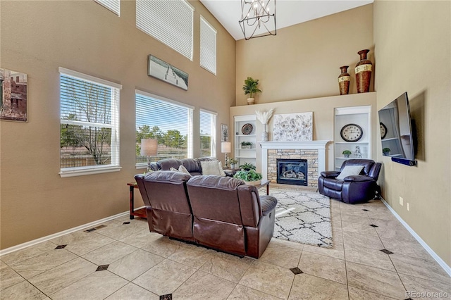 tiled living area with built in features, baseboards, an inviting chandelier, and a fireplace