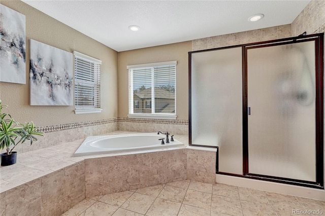 bathroom featuring a garden tub, a stall shower, and tile patterned flooring