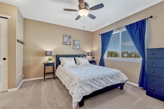 carpeted bedroom featuring a ceiling fan and baseboards