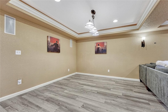 basement with crown molding, baseboards, light wood-type flooring, and a textured wall