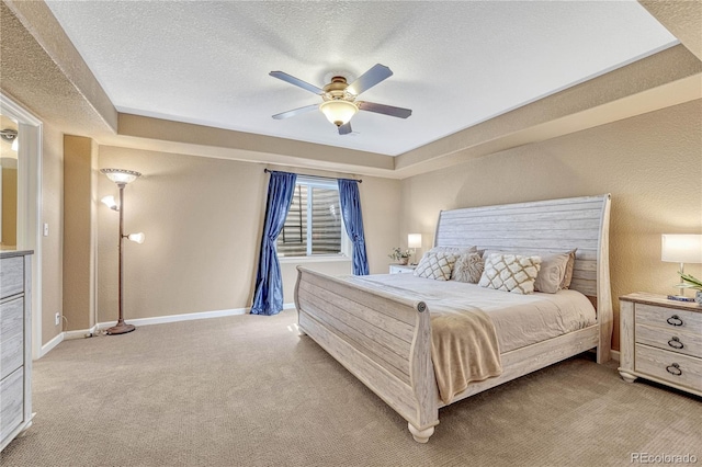 carpeted bedroom featuring a textured ceiling, baseboards, and a ceiling fan