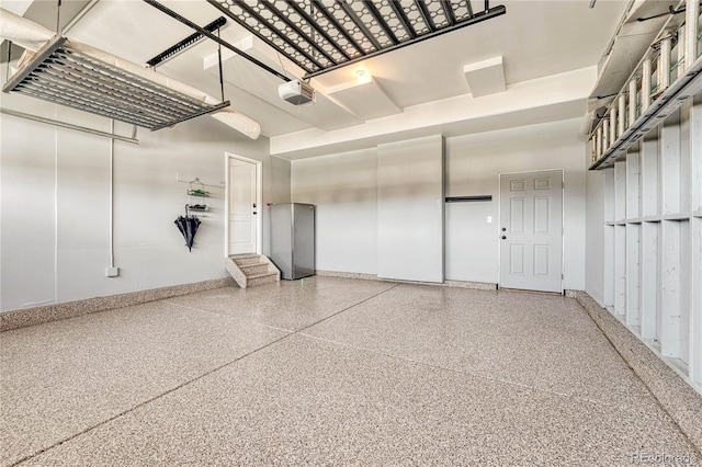 garage featuring a garage door opener and baseboards