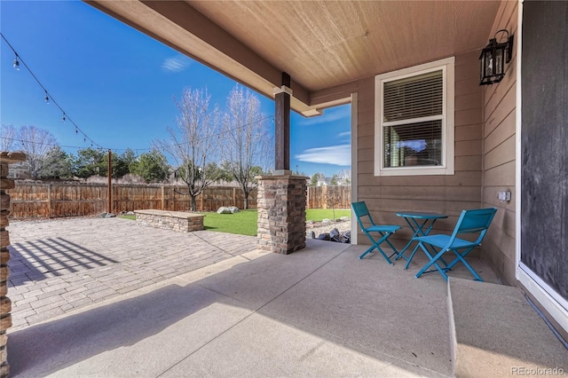 view of patio / terrace featuring fence