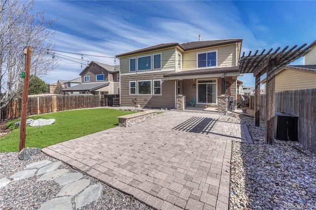 rear view of house with a yard, a patio, a fenced backyard, and a pergola