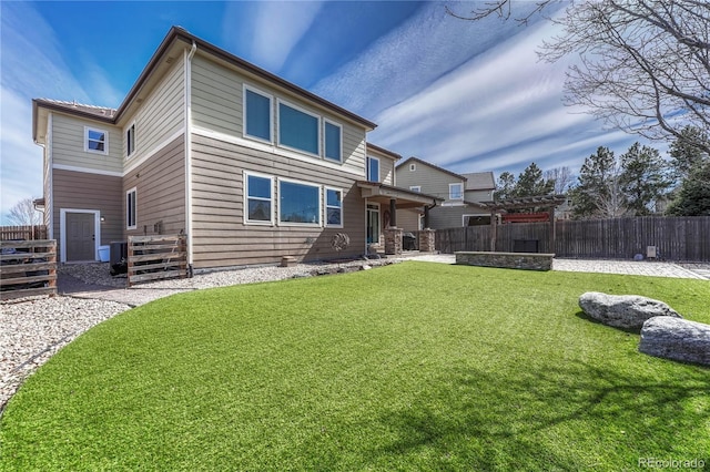 back of property with a yard and a fenced backyard