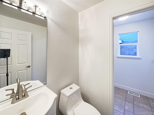 bathroom featuring vanity, toilet, and tile patterned floors