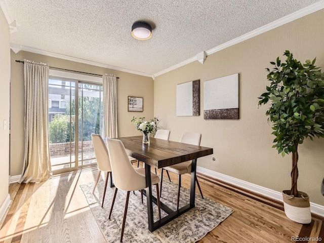 7826 S Niagara Way, Centennial, CO 80112 - dining space featuring a textured ceiling, crown molding, and light wood finished floors