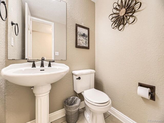 7826 S Niagara Way, Centennial, CO 80112 - half bath with a textured wall and tile patterned floors