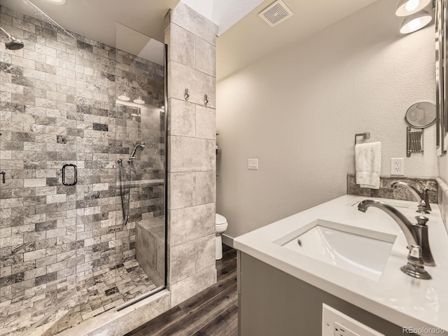 7826 S Niagara Way, Centennial, CO 80112 - full bathroom featuring double vanity, wood finished floors, and a shower stall