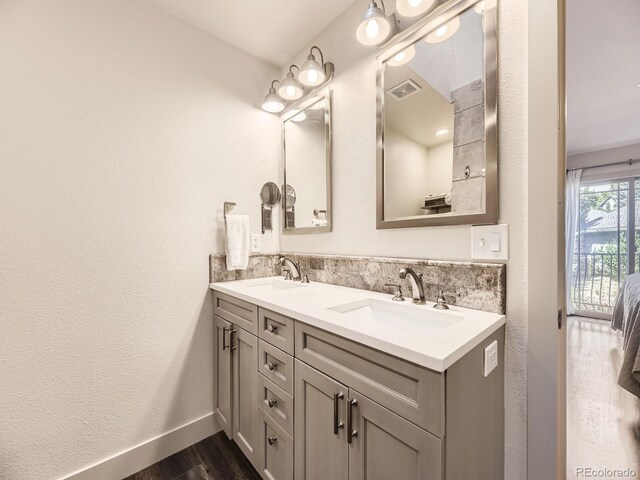 7826 S Niagara Way, Centennial, CO 80112 - bathroom featuring double vanity and wood finished floors