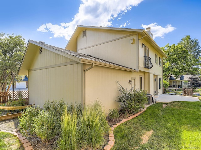7826 S Niagara Way, Centennial, CO 80112 - view of side of home with a patio area and roof with shingles