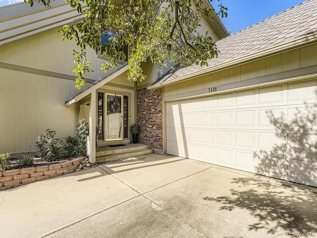 7826 S Niagara Way, Centennial, CO 80112 - property entrance with driveway, brick siding, and an attached garage
