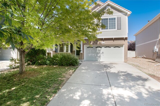 view of property hidden behind natural elements featuring a garage