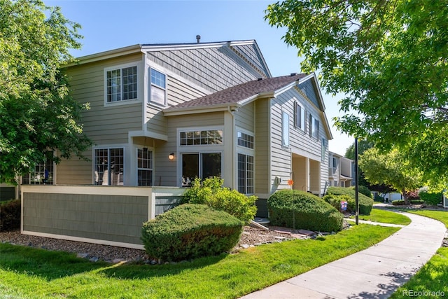 930 Button Rock Dr Unit 28, Longmont, CO 80504 - rear view of property featuring a lawn