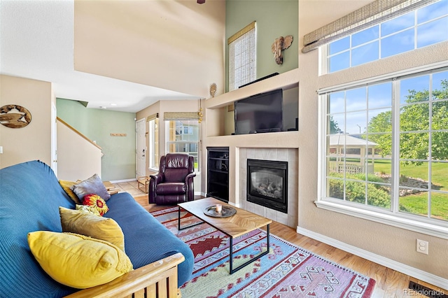 930 Button Rock Dr Unit 28, Longmont, CO 80504 - living area with plenty of natural light, a tile fireplace, baseboards, and stairway