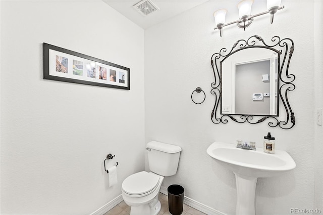 930 Button Rock Dr Unit 28, Longmont, CO 80504 - bathroom featuring toilet, baseboards, tile patterned floors, and a sink