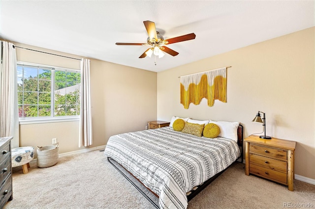 930 Button Rock Dr Unit 28, Longmont, CO 80504 - bedroom featuring light carpet, baseboards, and ceiling fan