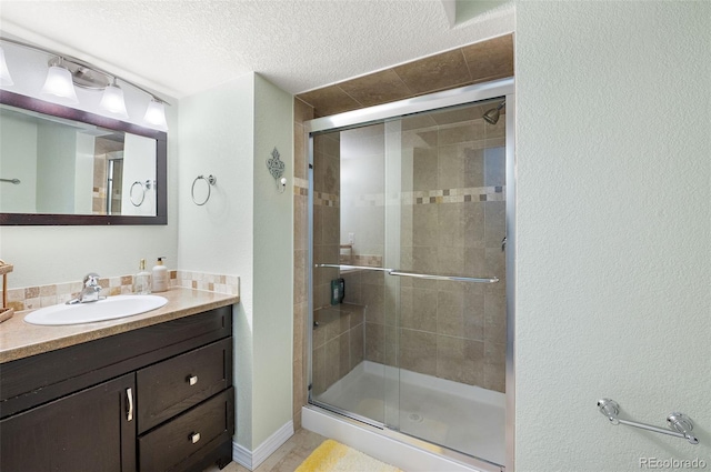 930 Button Rock Dr Unit 28, Longmont, CO 80504 - full bathroom with vanity, a shower stall, and a textured ceiling