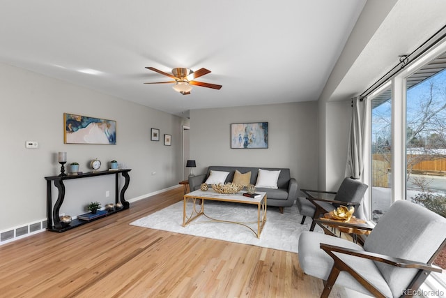 living room featuring ceiling fan and hardwood / wood-style flooring