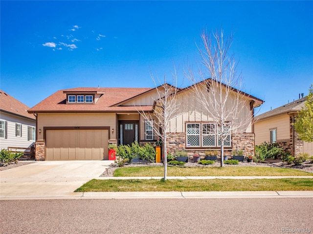 craftsman inspired home with stone siding, a garage, driveway, and board and batten siding