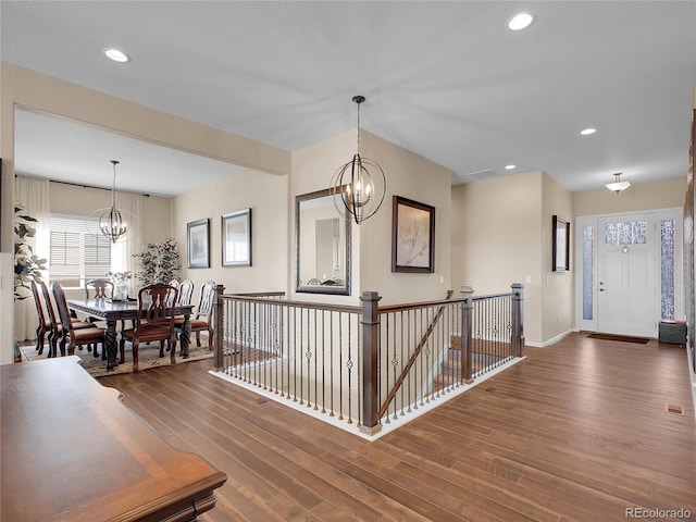 entrance foyer featuring a chandelier, wood finished floors, plenty of natural light, baseboards, and recessed lighting