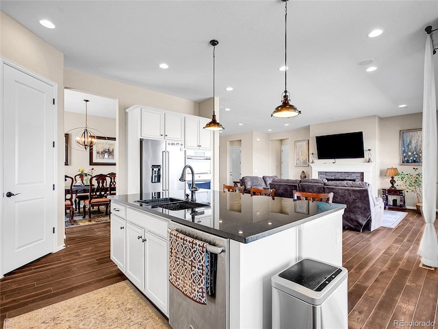 kitchen featuring stainless steel appliances, dark wood-style floors, a sink, white cabinetry, and recessed lighting