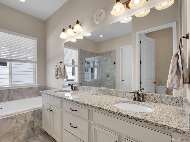bathroom featuring plenty of natural light, a shower stall, double vanity, and a bath