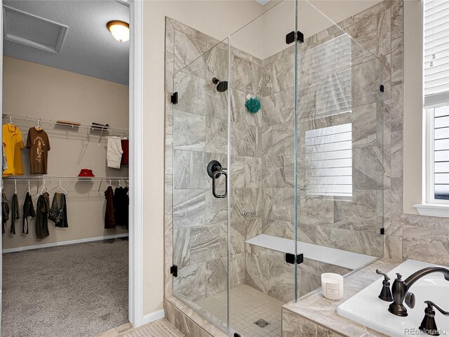 bathroom with a shower stall, a garden tub, and a walk in closet