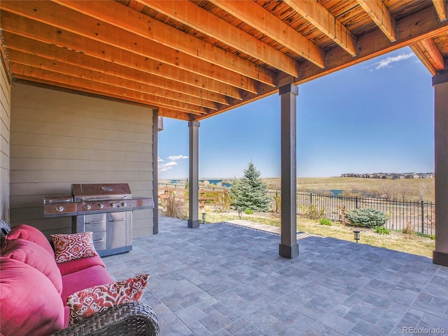 view of patio with a grill and fence