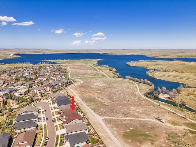 view of property location with a large body of water and nearby suburban area