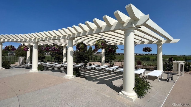 view of patio / terrace with a pergola and fence