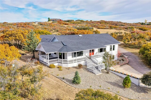 810 N Perry Park Rd, Sedalia, CO 80135 - rear view of property with covered porch and a shingled roof