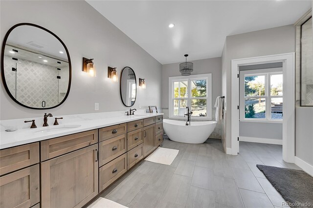 810 N Perry Park Rd, Sedalia, CO 80135 - bathroom featuring a freestanding tub, double vanity, a stall shower, baseboards, and recessed lighting