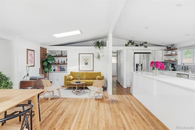2525 S Meade St, Denver, CO 80219 - living room with vaulted ceiling and light wood finished floors