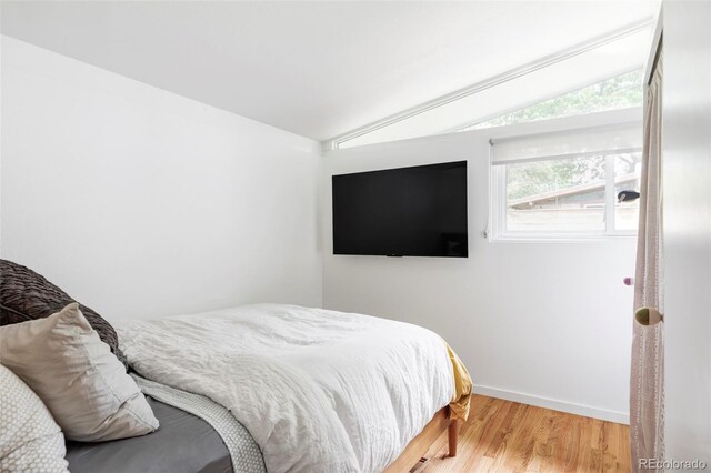 2525 S Meade St, Denver, CO 80219 - bedroom with lofted ceiling, wood finished floors, and baseboards