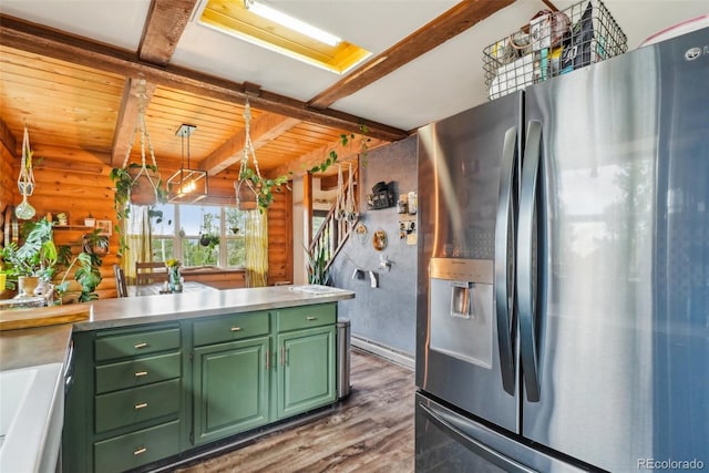 143 Juniper Rd, Black Hawk, CO 80422 - kitchen with stainless steel fridge with ice dispenser, green cabinetry, wood finished floors, wooden ceiling with exposed beams, and light countertops