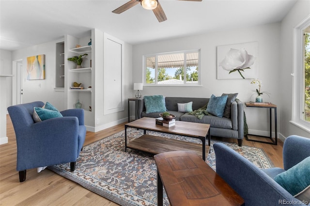 living room with light wood-type flooring and ceiling fan