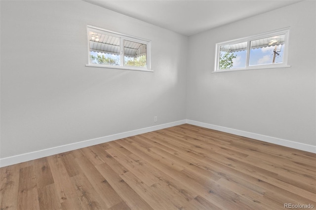 unfurnished room with plenty of natural light and light hardwood / wood-style floors