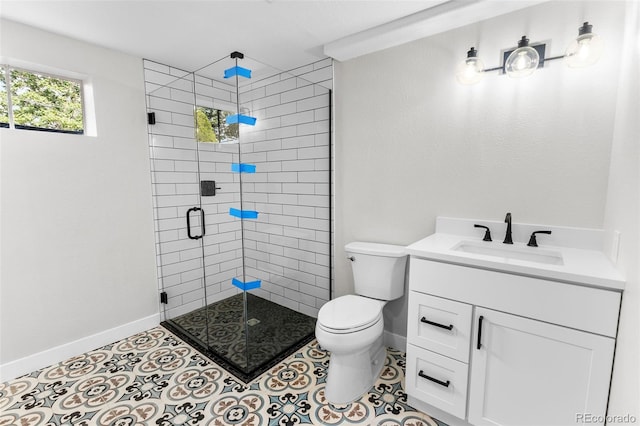 bathroom with vanity, a shower with door, tile patterned floors, and toilet